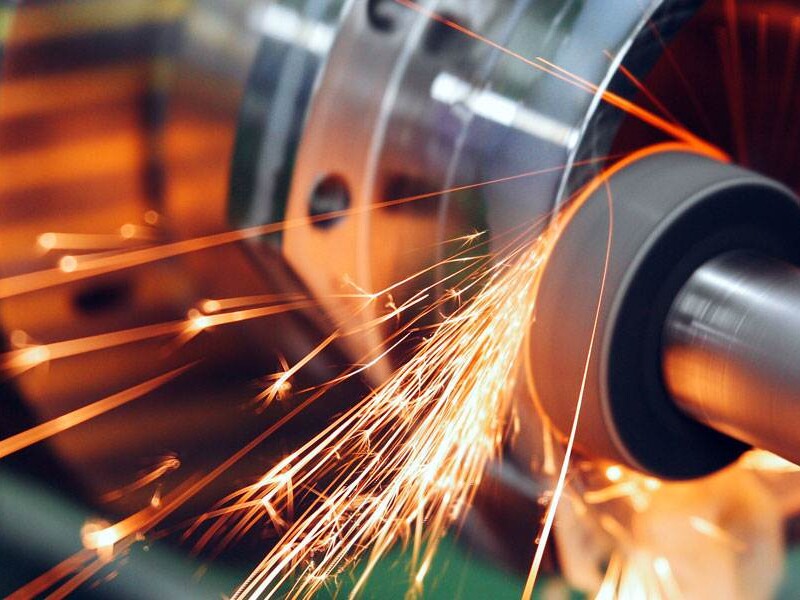 Precision Metal Grinding Process In Industrial Machinery, Showcasing Quality Manufacturing For Premium Grease Fittings And Nipples.