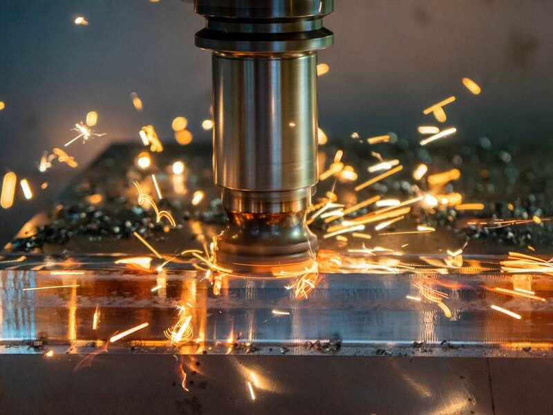 Close-Up Of Precision Cnc Milling Machine Cutting Metal, Sparks Flying—Showcasing High-Speed Manufacturing For Industrial Fittings.